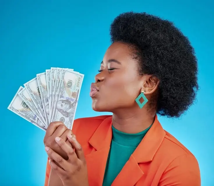 A professional celebrating with US dollar notes